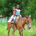 Boys riding a horse in the Rural areas, Dominican Republic