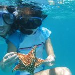Katie holding a Star fish, Snorkeling